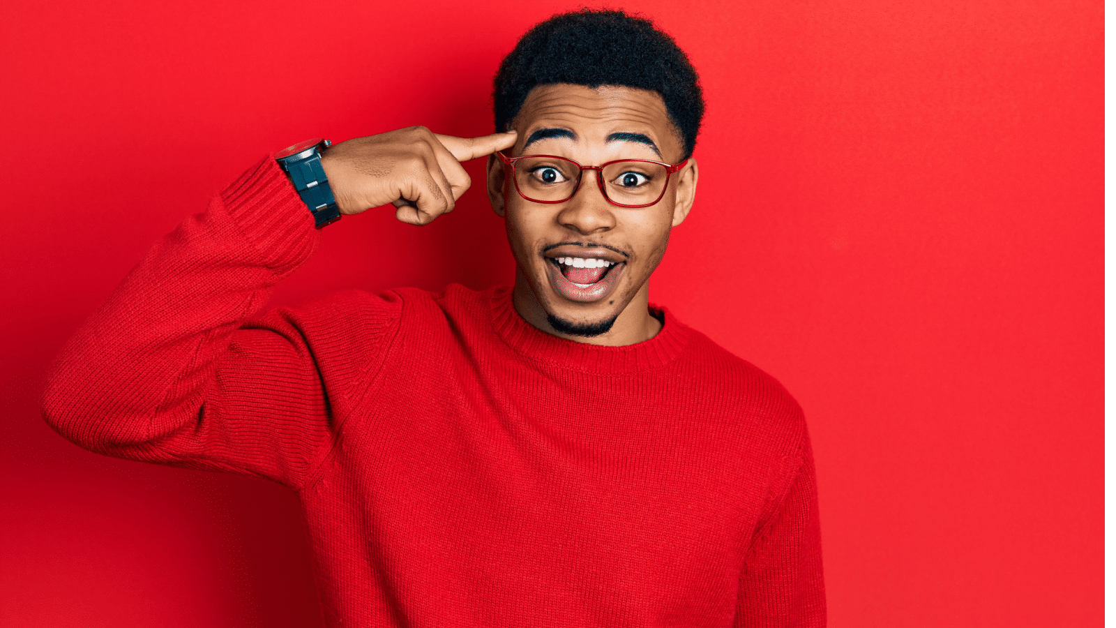 Black man pointing to head thinking