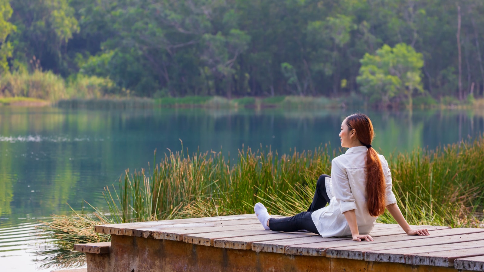 woman sitting on dock nature