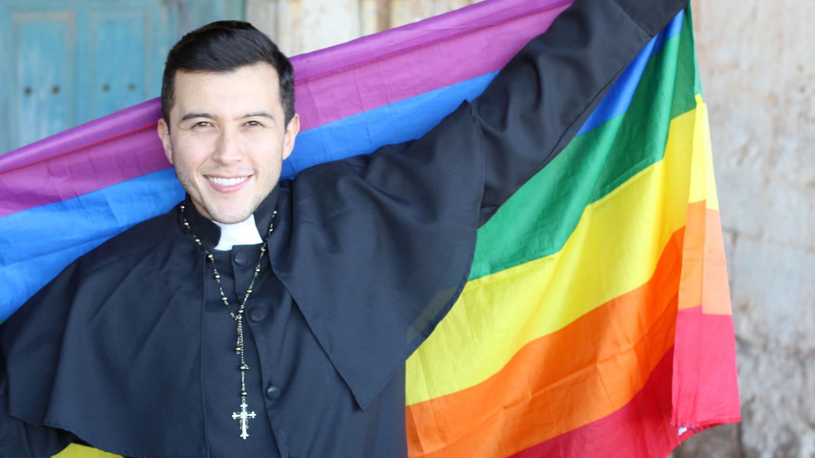 LGBTQ priest rainbow flag