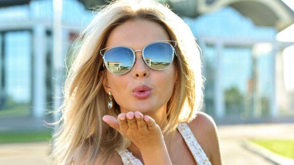 woman blowing kiss sunglasses