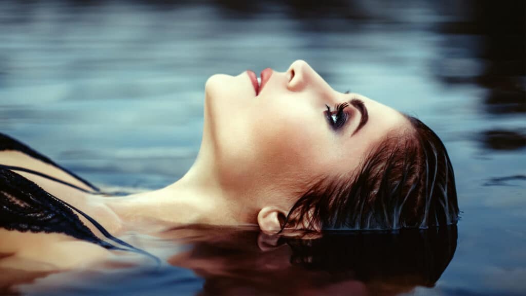 beautiful woman floating on water