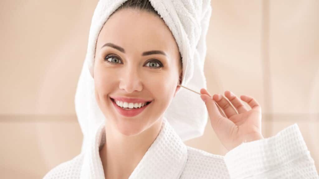 woman cleaning ears with Q-tip