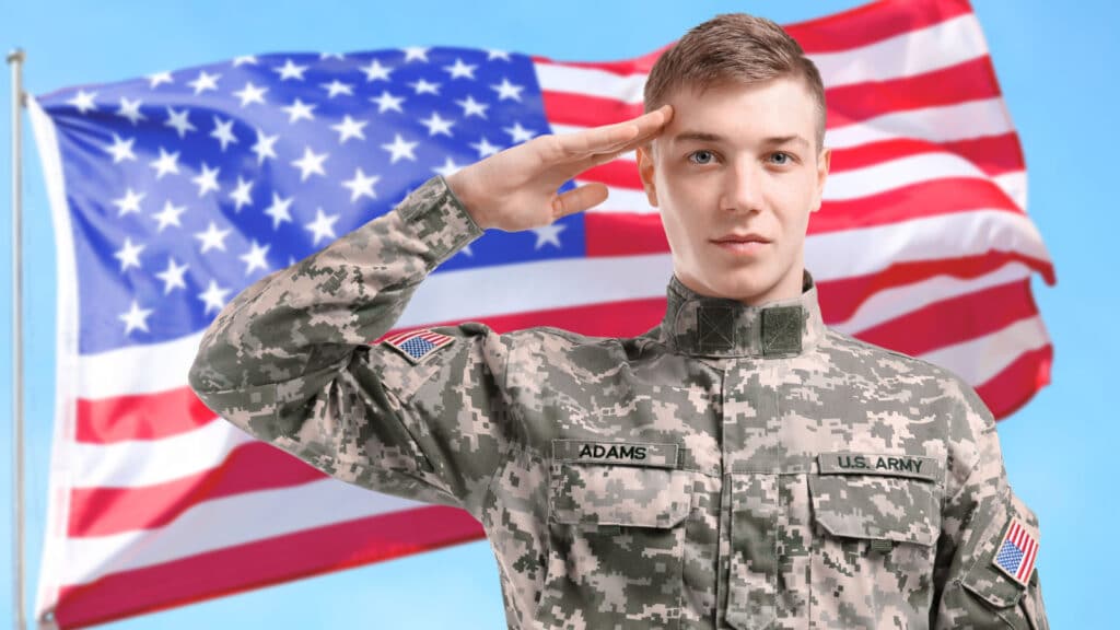 Young American soldier salute flag