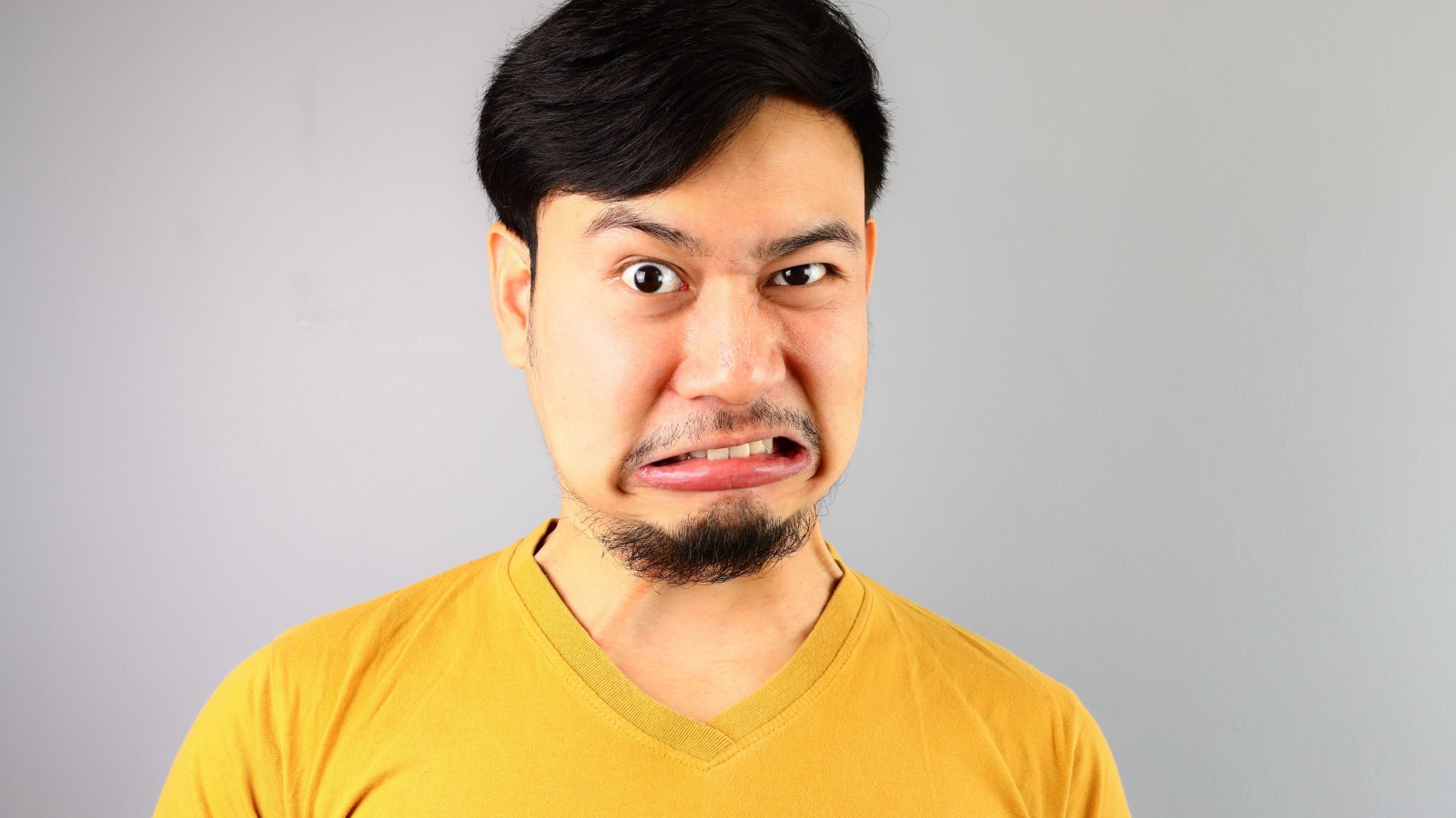 Asian man disgusted judging face