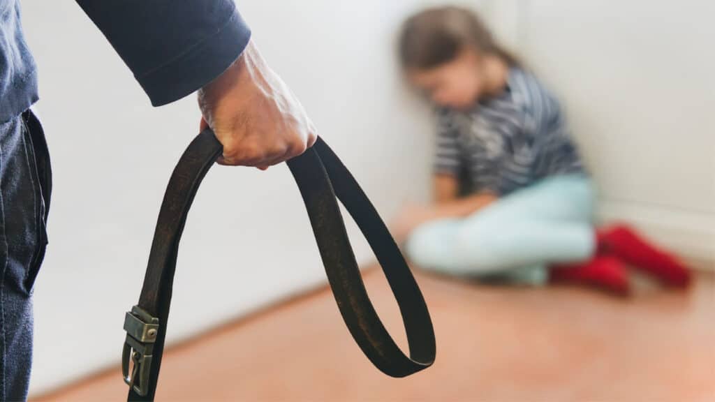 child abuse kid cowering spanking belt