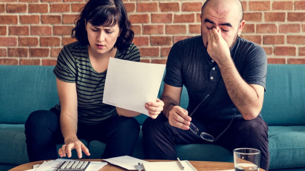 couple stressing finances mortgage bills