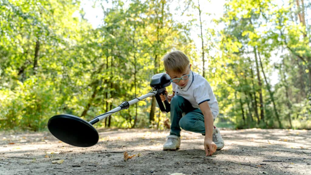 kid with metal detector