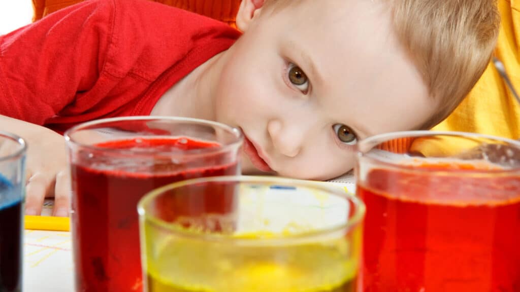 little boy looking at food dye