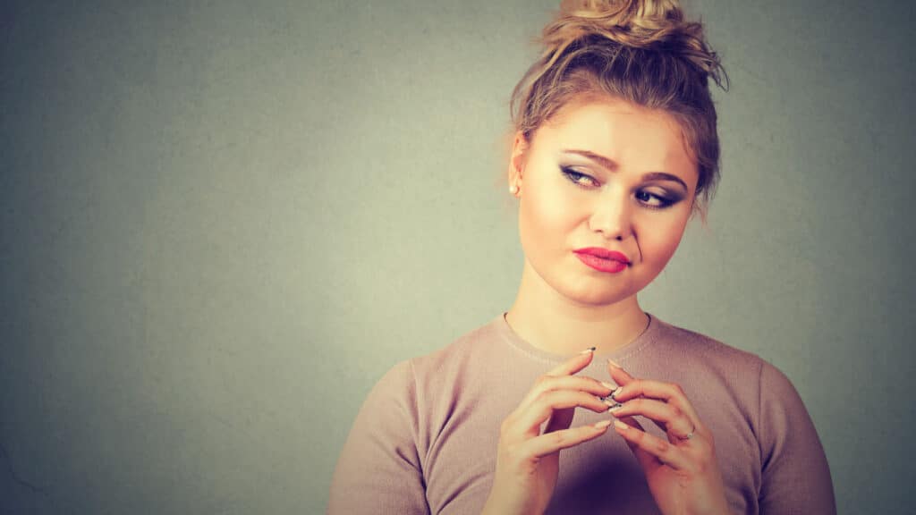 sneaky manipulative woman hands together reaction