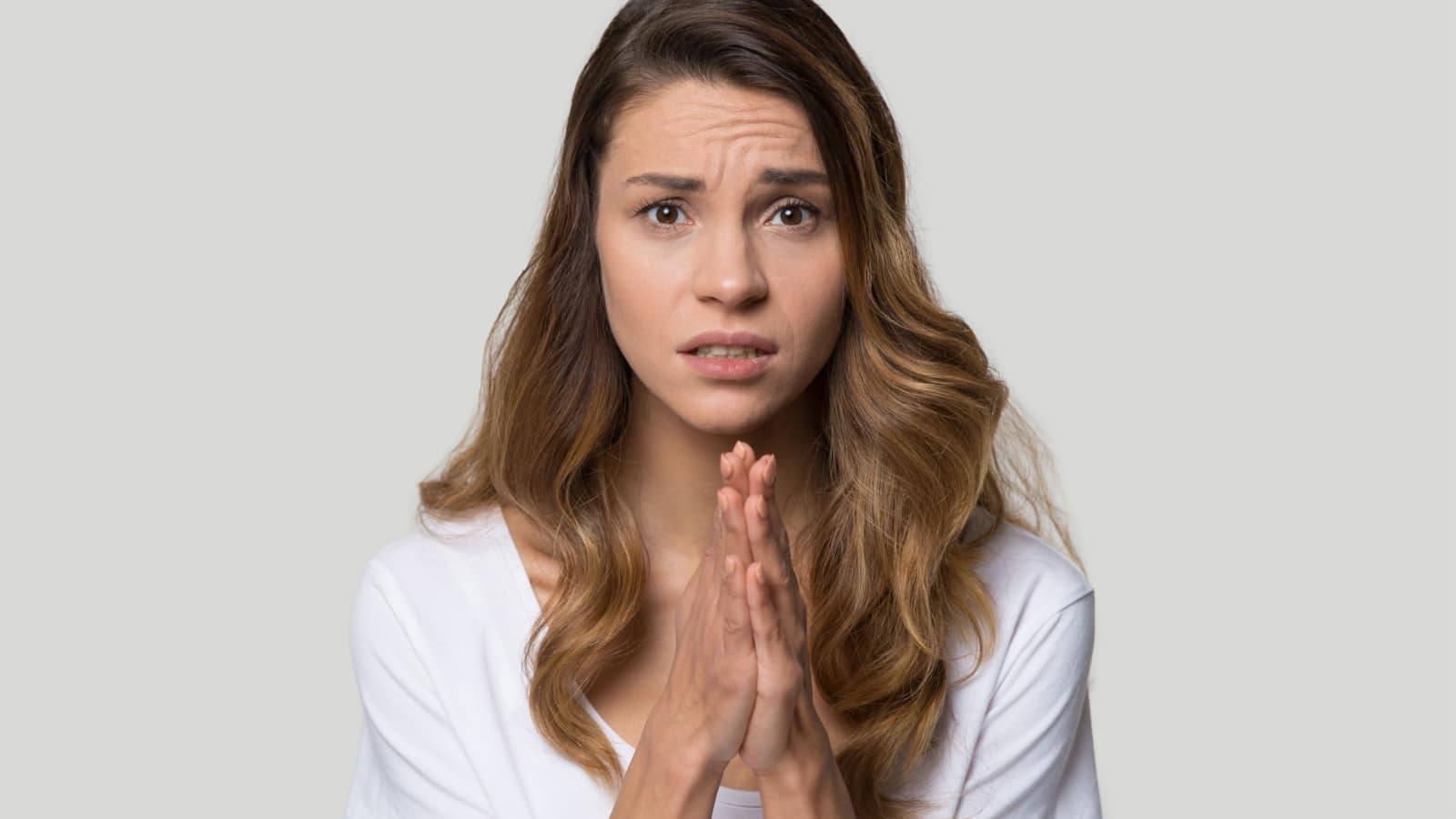 woman praying hands sorry please