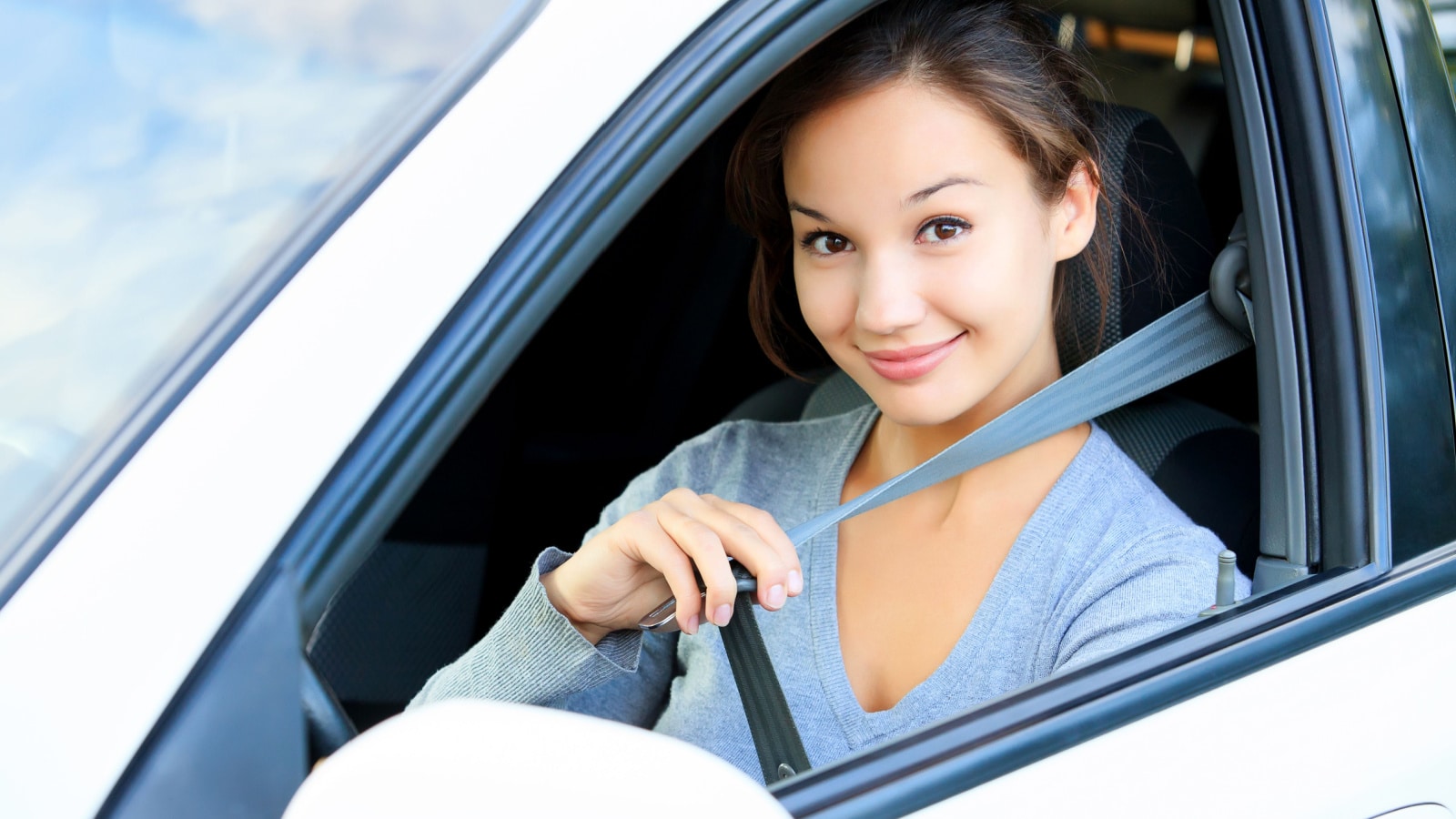 putting on seatbelt car driving
